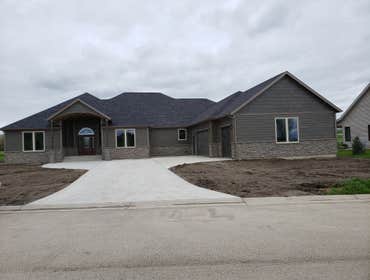 Photos by North Country Construction Inc #1 We built this gorgeous 5,000 SF house for a client in the powderhorn. It has a attached 3 car garage on a n