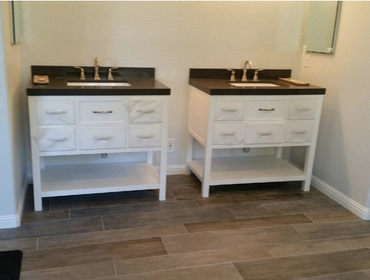Rustic Bathroom Remodel in San Jose For a more rustic look, the floors were outfitted with distressed wood. A stand-alone tub and matching his and hers