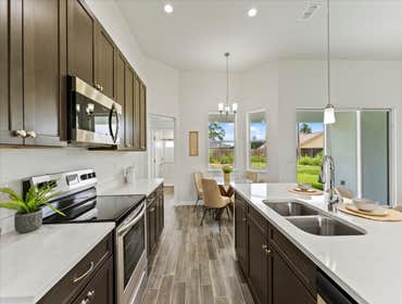 Photos by Luxar Homes #2 We LOVE a good contrast in a home! The dark cabinets and flooring really bring out the beautiful details in our Quartz counter