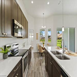 Photos by Luxar Homes #2 We LOVE a good contrast in a home! The dark cabinets and flooring really bring out the beautiful details in our Quartz...