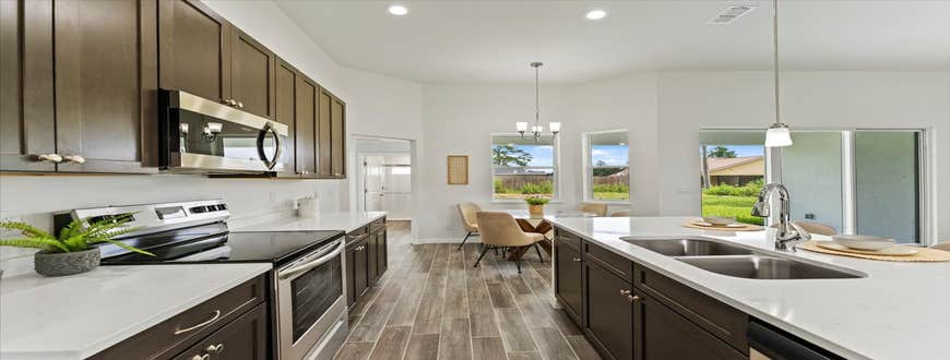 Photos by Luxar Homes #2 We LOVE a good contrast in a home! The dark cabinets and flooring really bring out the beautiful details in our Quartz cou...