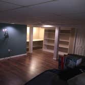 Photos by J. Roberts Installations #4 finished basement. laminate flooring, book shelf and a desk