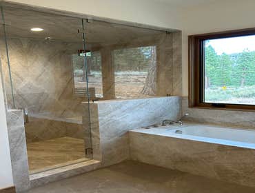 Martis Camp, Truckee quartzite slab bathroom Taj Mahal 3/4” thick natural quartzite slab steam shower and tub enclosure, including ceiling lid and show