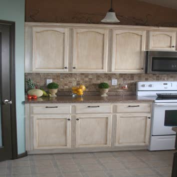 Clearfield We refinished the kitchen cabinets and counters, install a new tile back splash and replace the pantry door.