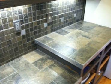 Lake Stevens Kitchen Remodel We installed a porcelain tile counter top and backsplash accented with aluminum strips and squares. Aluminum flat bar was