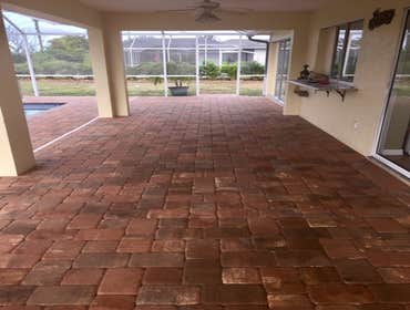 Pool Enclosure and Brick Pavers White Pool Enclosure with charcoal screen set over Euro Sunset, Yellow, Chocolate pavers.