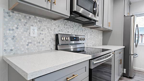 Multicolor tile backsplash and modern countertops