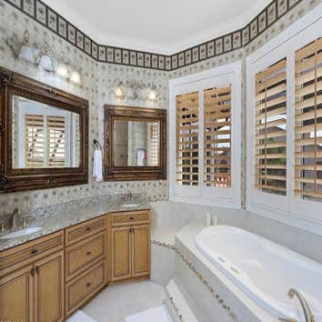Bathroom Remodel Master bathroom with new vanities with marble tops and undermounts sinks with all new faucets and hardware. Wallpaper and plantation s
