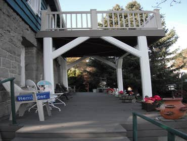 Stone House Remove cabinets and window, add wall closet to bedroom, install sliding door, tile on inside of slider, add secound story deck to front of 