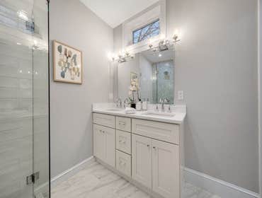 Photos by LCG BOSTON LLC #1 Full Home Remodel. Bathroom with custom glass, kitchen remodel with a beautiful exposed brick.