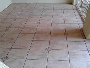 Exterior patio Outside front patio. 12x12 porcelain tile with random dot inserts
