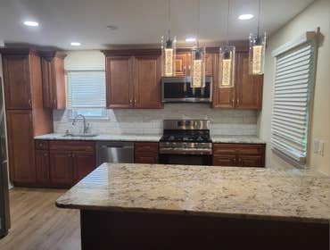 Photos by M&c Global Construction LLC #7 This Baltimore, MD, kitchen remodel created a modern open-concept design featuring granite countertops, recess