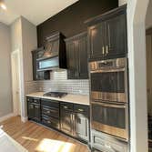 Photos by Austin Fine Finish Painting LLC #1 46 Piece Cabinet repaint. Benjamin Moore Satin Impervo color matched to SW Tricorn Black. Photos taken d