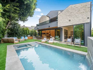 Burnet Project This Stunning modern home with a beautifully designed driveway featuring large concrete pavers with turf inlays, creating a sleek and co