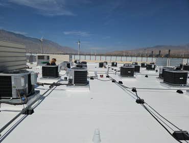 Installation of IB Roof Systems 50 Mil PVC Membrane Cool Roof Recover on commercial flat roof over 1/2" fanfold separation EPS.
