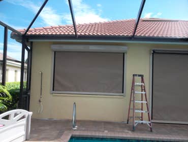 Electric Hurricane Screens Electric Hurricane Roll-up Screen covering rear lanai area. Great product for hurricanes, sun protection, keeping lanai's dr