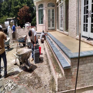 PAVER PATIO, STEPS AND SITTING WALLS GIVE CLIENT A NEW PATIO AND LANDING FOR THE BACK OF HOUSE, AREA FOR GRILLING AND NEW STEPS TO GO TO LOWER PATIO AR