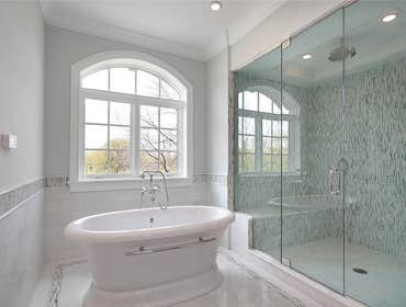 Bath White porcelain with glass tile. Shower features a bench and tray ceiling. Pedestal tub provides a timeless feel to the room.