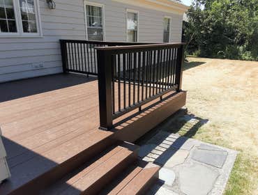 Wolf Acacia Decking and Drink Rail Top With Wolf Acacia Trim and Black Composite Railings