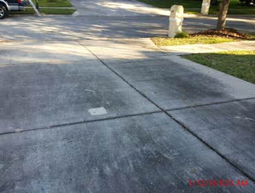Photos from Popa Construction LLC Before & Afters of a soft wash roof cleaning and driveway and side walk cleaning.