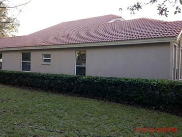 Photos from Popa Construction LLC Before & Afters of a soft wash roof cleaning and driveway and side walk cleaning.