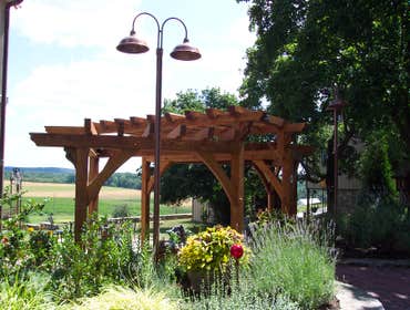 (2) Custom designed timber-framed pergola, timber-framed carport Each timber is hand carved to fit into the joining beam.