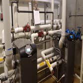 Photo(s) from Radiant Floor Heating Specialist Commercial boiler room with Lochinvar boilers and piping, Trucking companies Clean Burn waste oil burnin