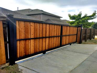 Photos by Art Construction #2 Driveway Gate Cedar Pickets Board on board 26x8 Ft with motor . Extra fence 8 ft Tall . Not included Electrical