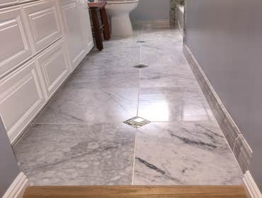 Marble bathroom floor 18"x18" marble with mosaic glass inlays.