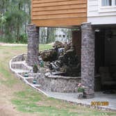 Photo(s) from Home Renovations & Remodeling Wall of windows great room addition, deck & cypress porch with stone water fall, pond & patio
