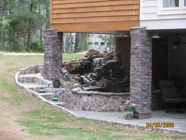 Photo(s) from Home Renovations & Remodeling Wall of windows great room addition, deck & cypress porch with stone water fall, pond & patio