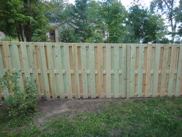 Minnewawa good neighbor fence. Treated wood good neighbor fence on property line.