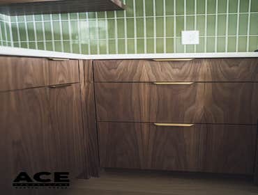 Contemporary Sophistication - Walnut and Green Tile Kitchen Remodel This beautifully remodeled kitchen, where modern elegance meets functionality. The 