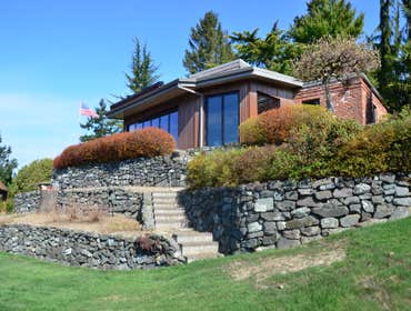 Expanding View All season sitting room opens home to views across the bay and Olympic Mountains beyond.