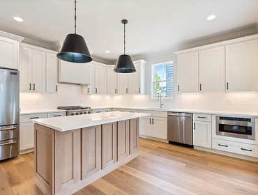 Bright chefs kitchen at 1135 Delmas Ave, East Nashville by CJMC Build: quartz counters, shaker cabinets, undercabinet lighting, and a pro style range w