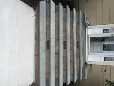 Photo(s) from Mcgrane Property Maintenance LLC. Walkway installation with concrete walkways, tread stock steps and EP Henry block as the raisers lights