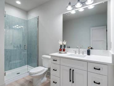 Crisp guest bath with shaker vanity, quartz top, and glass shower built by CJMC Build in 12 South, Nashville.