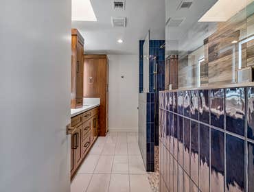 Falconer Remodel Full gut of primary bath and guest bath. Custom cabinets and tiling throughout. Curbless shower entry with dual shower areas.