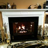 Gas Logs and Custom Mantel Custom Metropolitan Mantel by Forshaw, Gas Logs by Hargrove, traditional brass hearth accessories by Pilgrim, Minuteman, Ada