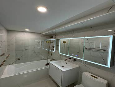 Bathroom Gut Renovation Evolution Group completed a full renovation of a modern bathroom, focusing on smart technology integration and meticulous proje