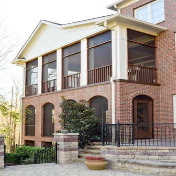 Screened Porch All cedar handrails and frame with hand-made laminated arches to maintain the beautiful, uncluttered view from inside.