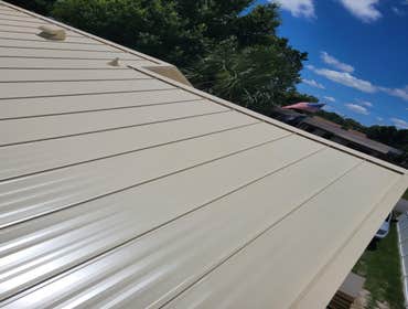 Photos by Steel Hammer Roofing and Construction LLC #32 Standing seam metal in Ivory, along with a flat roof replacement in the back of the house. Hom