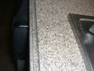 Project photos from Solid Surface Creations - DCI Excessive Heat at Cook Top Area Before/After