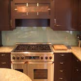 BCV Design kitchen project & other glass projects Round glass table on copper base, glass counter supported by stainless steel brackets and colored gla