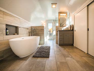 Attic Bathroom with Storage An attic with a bathroom, storage closets, a balcony, and access to the rest of the attic. Great use of the space given the