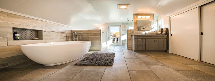Attic Bathroom with Storage An attic with a bathroom, storage closets, a balcony, and access to the rest of the attic. Great use of the space given...