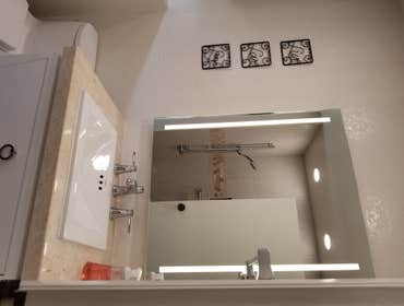V. Jones Bathroom/Laundry Room Remodel - Tub to Step-in Shower Conversion with Linear Drain
- New Vanity, Toilet, Sink, mirror, toiletries
- All new fl