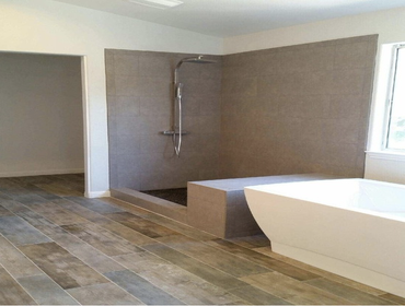 Rustic Bathroom Remodel in San Jose For a more rustic look, the floors were outfitted with distressed wood. A stand-alone tub and matching his and hers