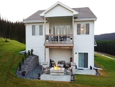 Perfect Backyard For Hosting Design and installation of complete outdoor living space including engineered retaining wall, custom firepit, broom-finish
