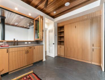 Murphy bed in poolhouse with passthrough bar